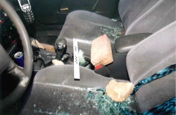 בנסיבות האלה, קשה לצפות ממנו שיעצור ויסייע. האבנים במכונית הדורסת (צילום: תיק המשטרה)
